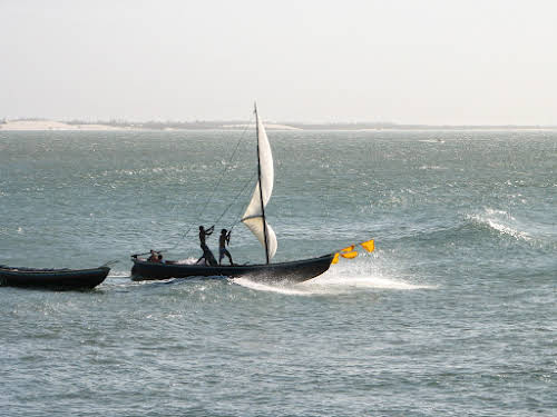 Fishermen boat braving the incoming waves