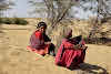 India. Rajasthan Thar Desert Camel Trek. An old lady and her grand-daughter stopping by.
