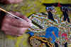 Indonesia. Crafts . Close-up on painting the leather puppet