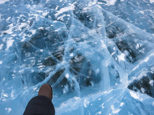 Standing over 3 feet of solid river ice