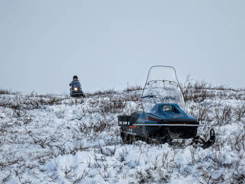 Bruno driving down his snowmobile