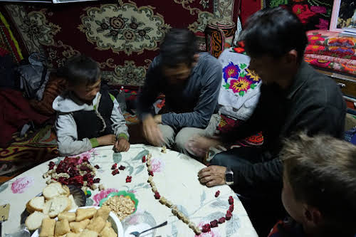 Bruno and Bek playing bones dice game with the kids