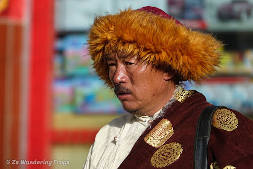 China Sichuan Kham Tibet Garze Ganzi Kandze Monastery Buddhist Festival // A Man Wearing the Traditional Tibetan Furred Robe: Left Shoulder Covered, Right Shoulder Exposed