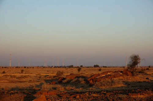 India, Rajasthan. Rising sun over the Thar desert windmills