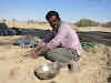 India. Rajasthan Thar Desert Camel Trek. Kitchen cleanup - desert style: with the sand!