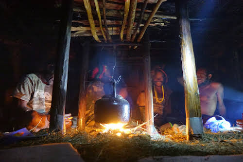 Indonesia. Papua Baliem Valley Trekking. Dinner time inside a traditional men's house in the Baliem Valley