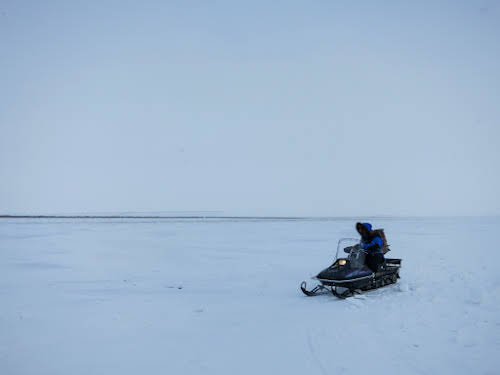 Bruno getting on his snowmobile