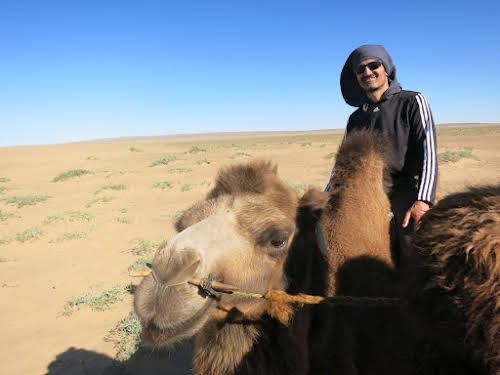 Bruno Riding a Camel by the Khongoryn Els Sand Dunes, Gobi Desert