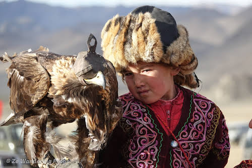 Mongolia. Golden Eagle Festival Olgii. One of the youngest girls with her eagle