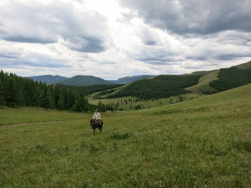 Mongolia. Gorkhi Terelj Horse Back Riding. Bruno Riding his horse to the pass