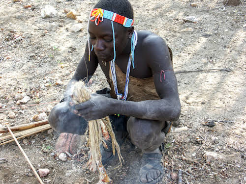 Hunter preparing a fire to cook the birds